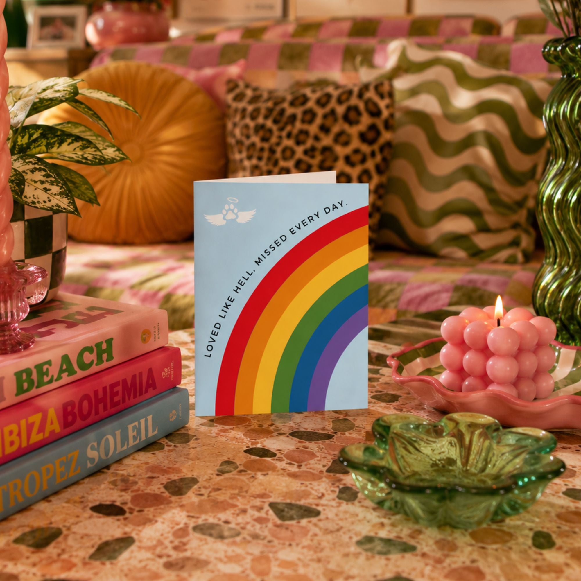 Pet loss sympathy card with a rainbow bridge design that reads 'loved like hell, missed every day.'