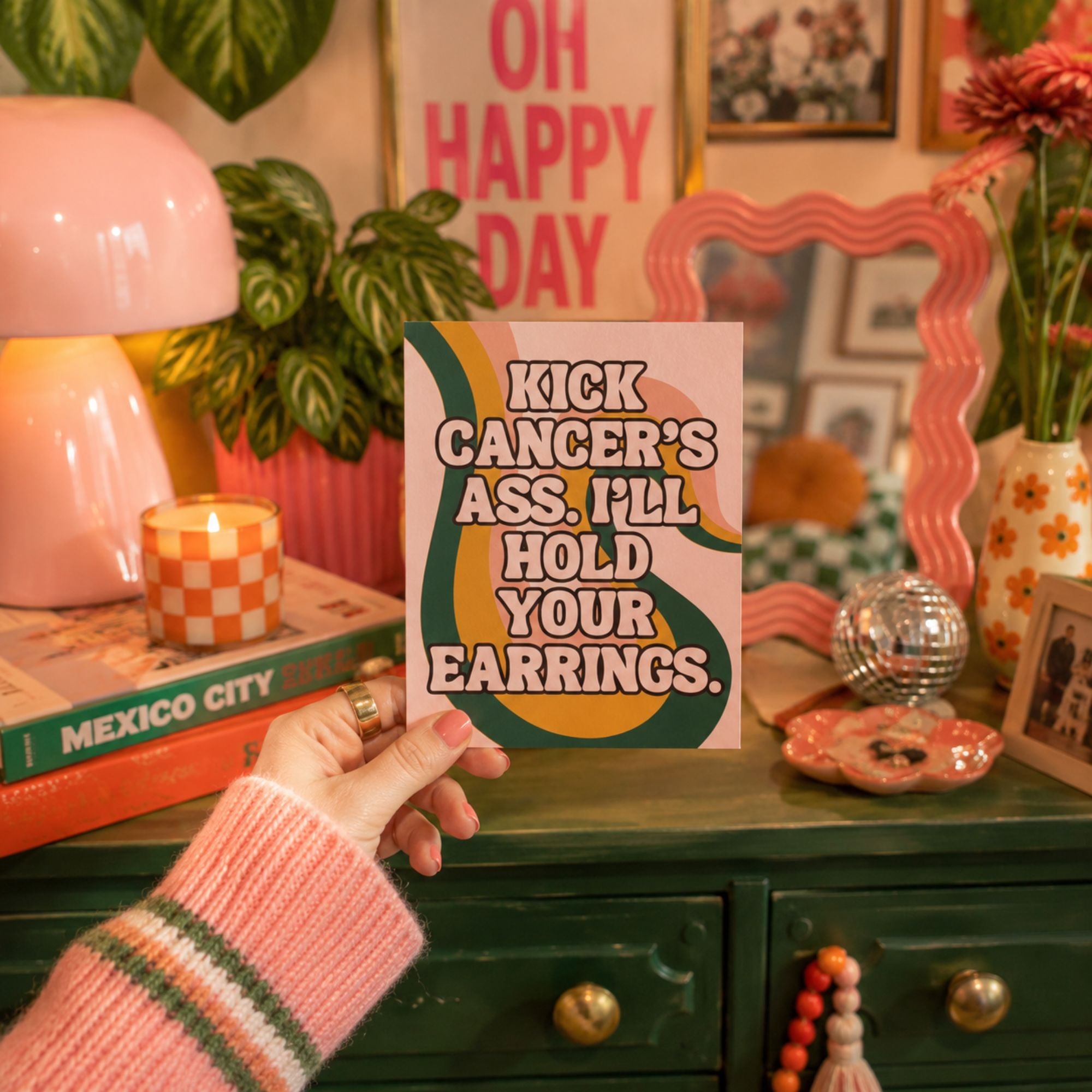 Funny cancer fighter support card that reads 'kick cancer's ass, I'll hold your earrings.'