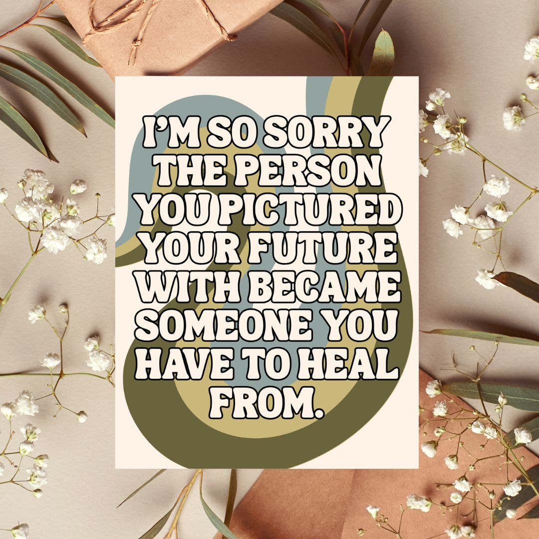 A square greeting card with a humorous apology quote, styled in a flat-lay with brown paper envelopes, green leaves, and white baby's breath flowers on a neutral beige background.